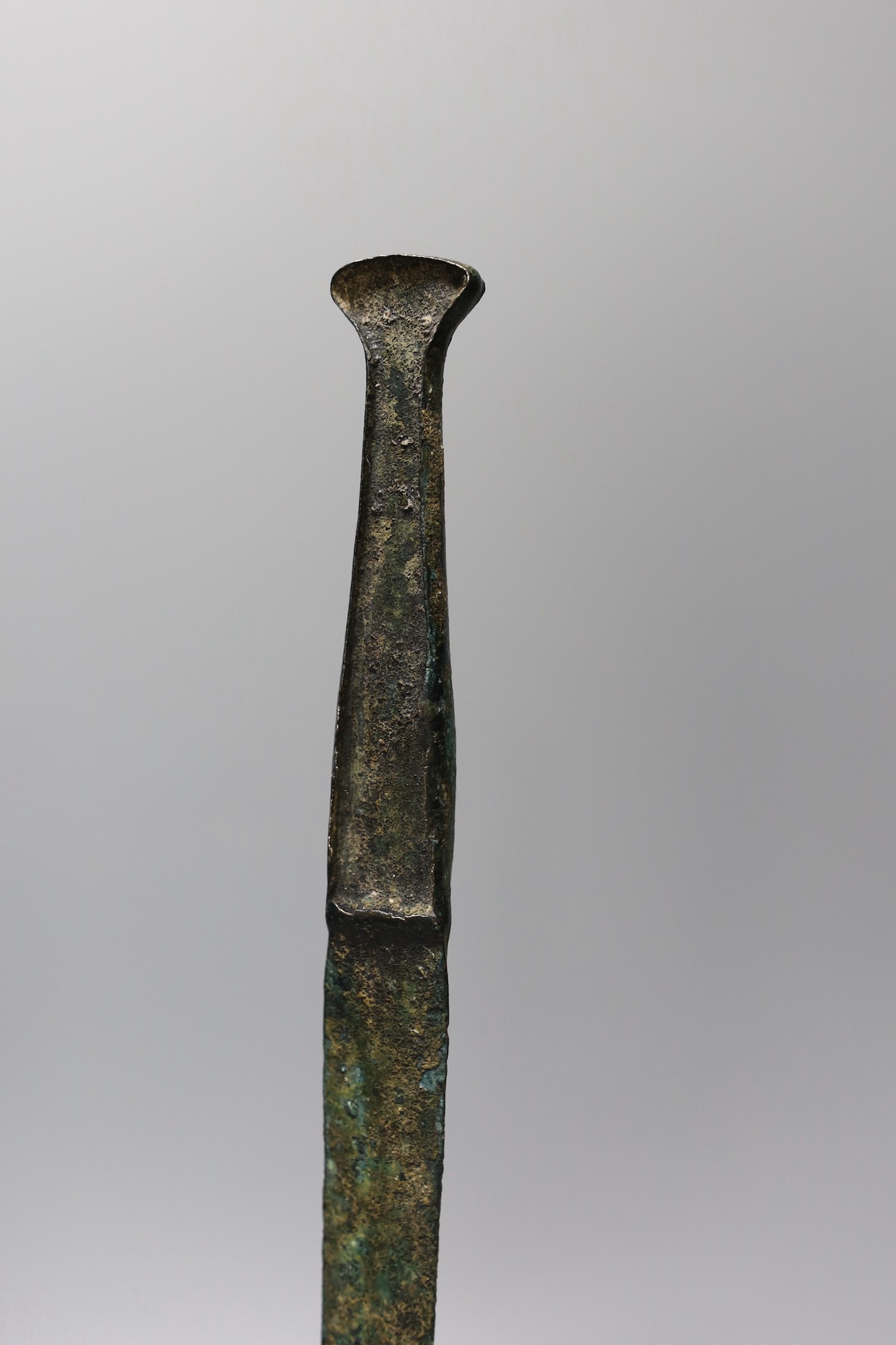 A Lurestan bronze dagger, on stand, 34.5 cms high.